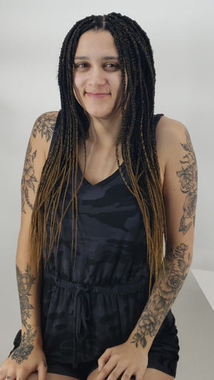 Long hair braiding in single box braids with braids extensions.